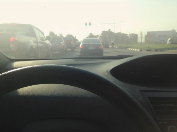 Driver on the steering wheel inside of a car