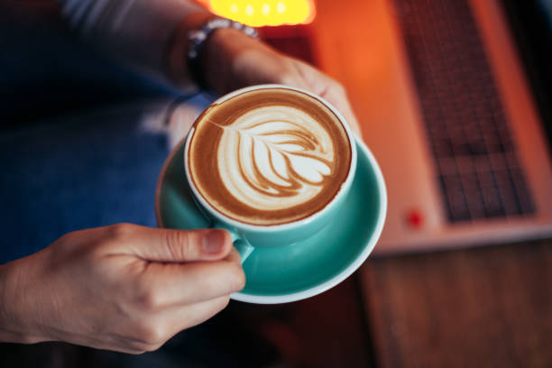 istock Woman holding cup with sth heart-shaped 951113254