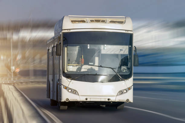 istock Modern transport bus on asphalt rides at high speed, front view. 951113614