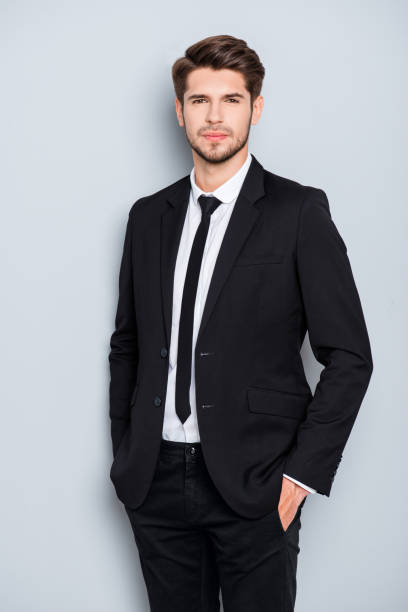 istock Handsome bearded man in suit holding hands in pockets 951117134