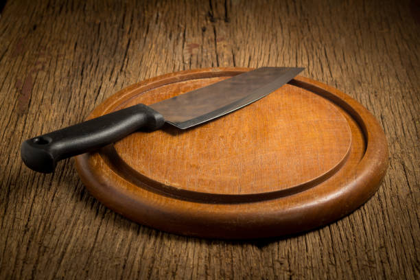 istock knife on cutting board on wood background 951120778