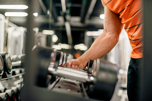 Man Is Picking Up Weights Stock Photo - Download Image Now - 20-29 ...