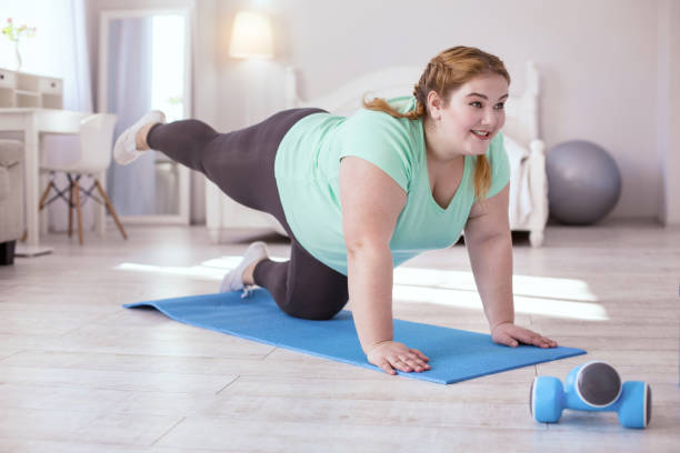 istock Smiling red-head woman doing exercises 951126214