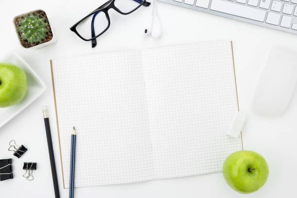 istock Notebook pages with grid lines is on top of whit office desk table. Top view, flat lay. 951126814