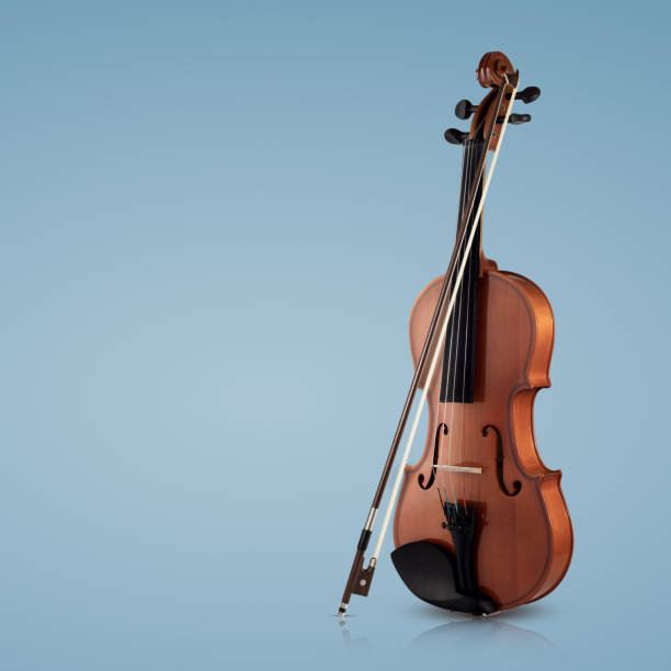 istock Violin musical instruments of orchestra closeup on blue 951126828