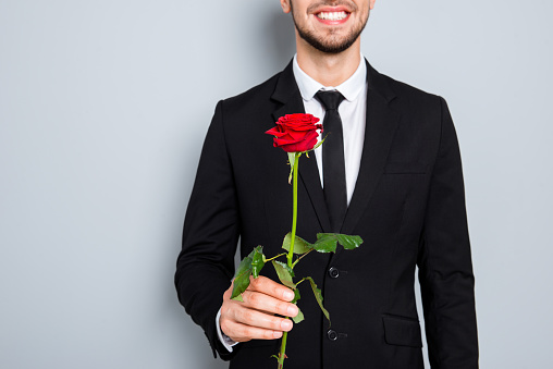 Close up photo of happy smiling businessman with red rose