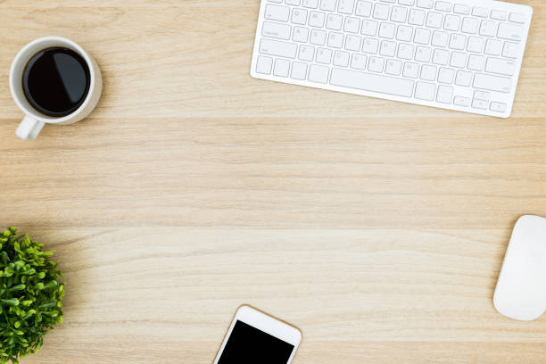 istock Minimal wood table with computer gadgets and supplies. Top view with copy space, flat lay. 951127182