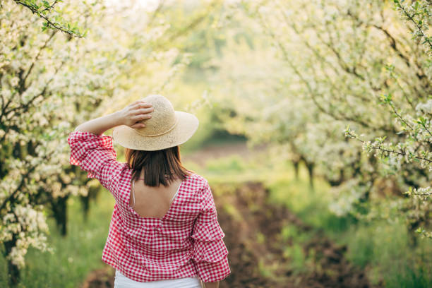 istock Woman standing in the orchard 951127556