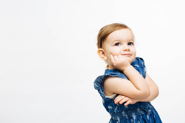 Little toddler child with arms crossed, thinking about something
