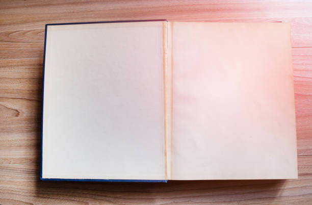 istock Open old book, vintage book on wooden background with soft sunlight with copy space. 951133314