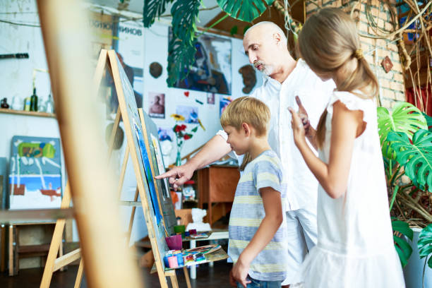 istock Mature Teacher Helping Kids in Art Studio 951133718