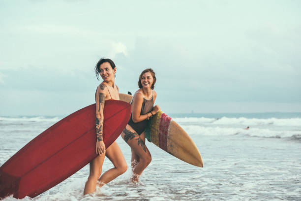 istock Female surfers at the beach 951134122