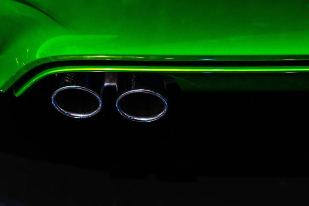 istock Dual chrome muffler on green rear bumper 951136034
