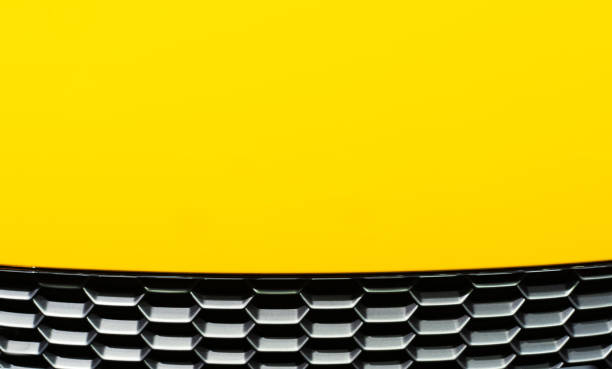 Abstract of yellow car hood with hive pattern stock photo