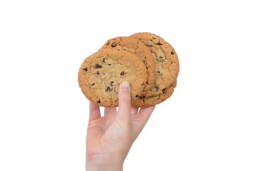 Child holding chocolate chip cookies in hand white background