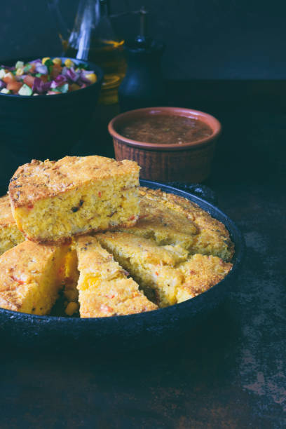 istock Cornbread and other mexican food - salsa with tomato, red onion, lime, cilantro, corn and hot pepper sauce. Copy space. 951136940