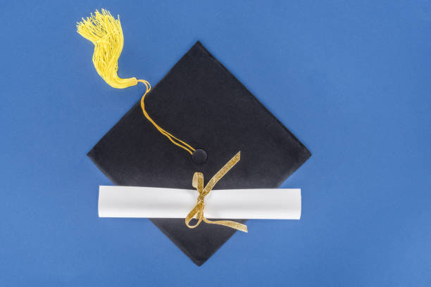 Graduation concept with diploma and graduation cap isolated on blue