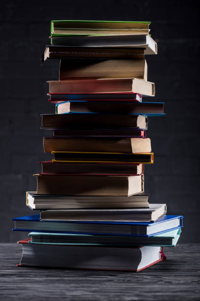 istock High stack of books on dark wooden background 951137450