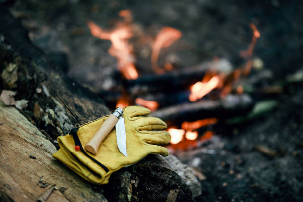 old yellow leather glove and pocketknife in camping