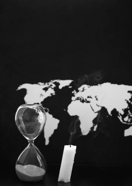 istock World map, sandglass and burnt candle, black background 951142362