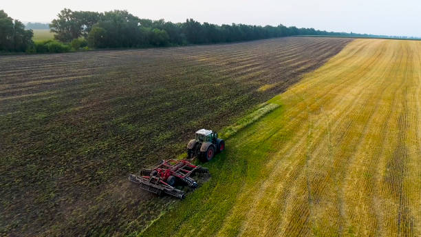 istock aerial tractor plowing field 951142504