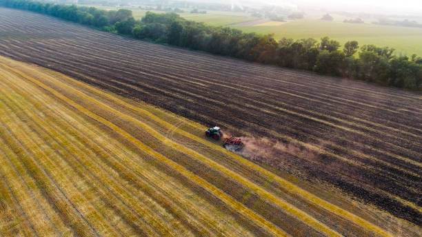 istock aerial tractor plowing field 951142588