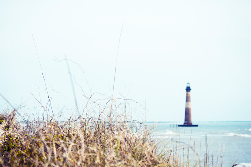 This is a color photograph of the Morris Island Lighthouse in Folly Beach, South Carolina.