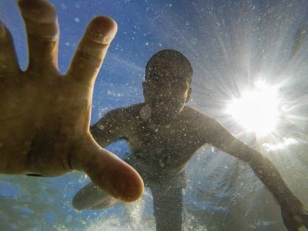 istock Man diving and grabbing something underwater with his hand 951143474