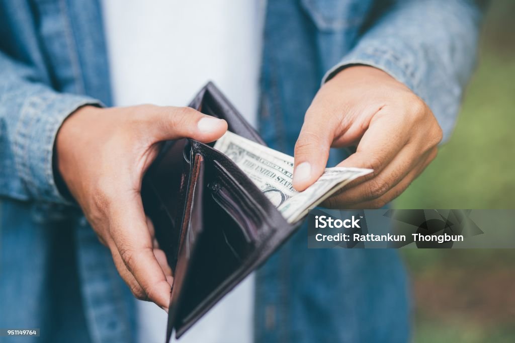 Businessman Person holding an wallet in the hands of an man take money out of pocket. Wallet Stock Photo