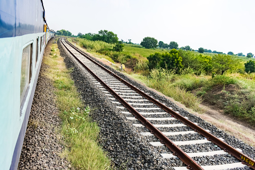 this snap has taken in running train with train a side view & a railway track.this snap has taken in running train with train a side view & a railway track.