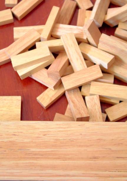 istock Dominoes fall on red wood floors. 951150710