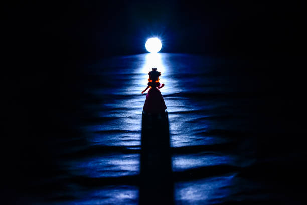Princess on  night water with lighting behind