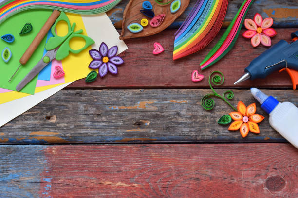 istock Quilling technique. Paper strips, flowers, scissors, elements. Handmade crafts on holiday theme: Birthday, Mother's Day, March 8, Wedding. Making decoration or greeting card. Children's DIY concept. 951154702