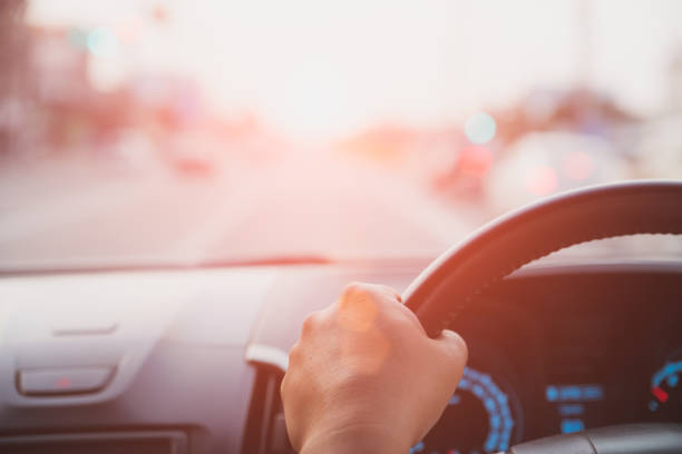 istock Soft focus driver hand holding steering wheel while driving on the road. 951155214