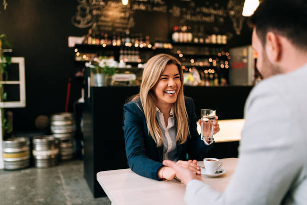 istock Laughing woman and man holding hands while enjoy coffee 951157810