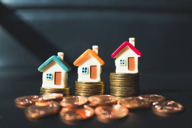 istock Miniature colorful houses with stack coins 951157928
