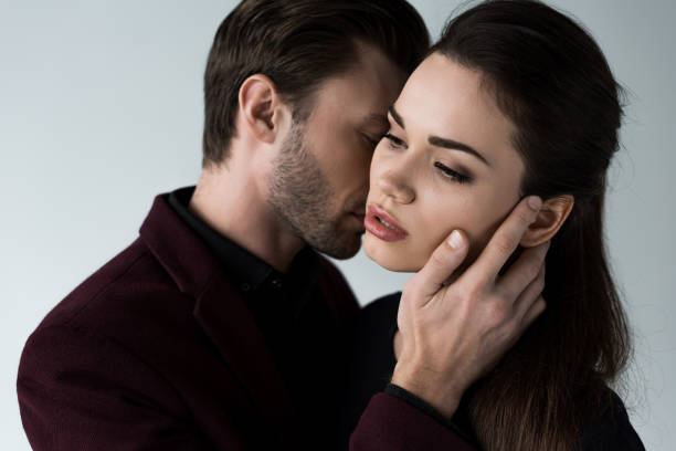 istock beautiful tender couple, isolated on grey 951163856