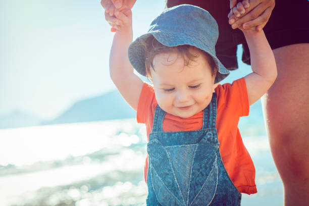 istock Baby learning to walk on the beach 951164452