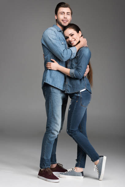 istock happy couple hugging and looking at camera, on grey 951164592