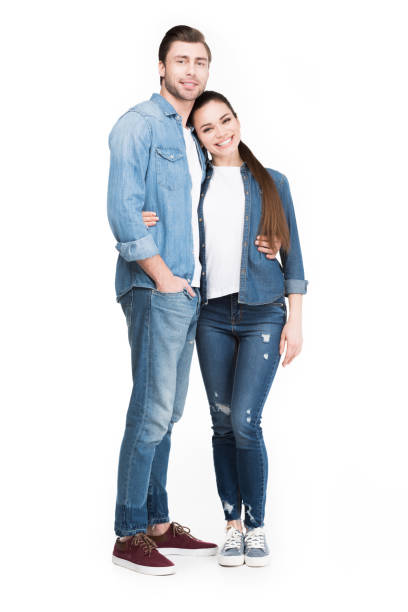 istock smiling young couple hugging and looking at camera, isolated on white 951168400