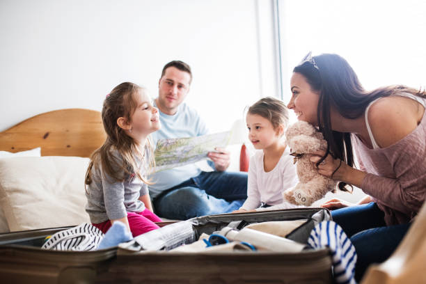 istock Young family with two children packing for holiday. 951172012