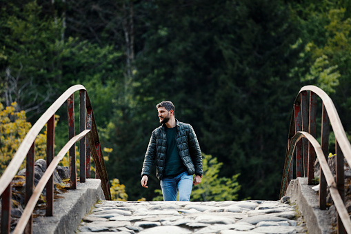 Handsome man walking in the spring park