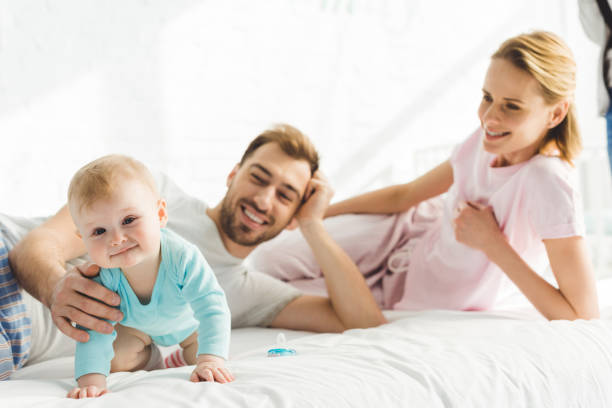 istock Happy young parents with infant daughter in bed 951173710