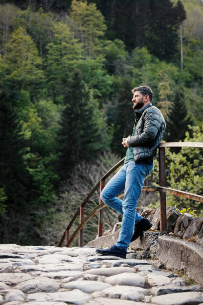 The handsome man looks over the forest
