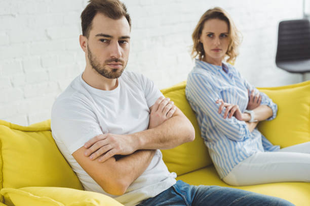 istock Young upset couple sitting on couch after argue 951177132