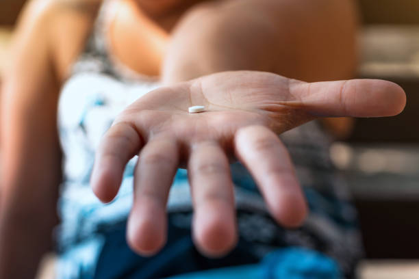istock Woman showing a pill. Pregnant concept 951177880