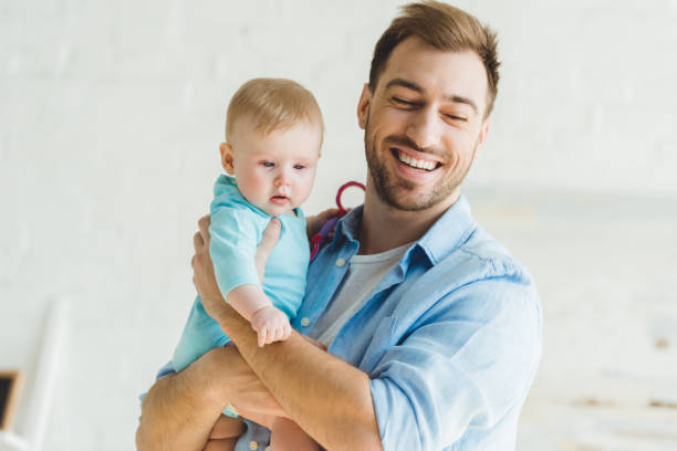 istock Happy young father holding infant daughter in hands 951178138