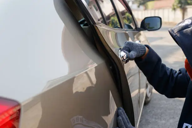 Photo of Male thief tries to steal a car. Car theft concept