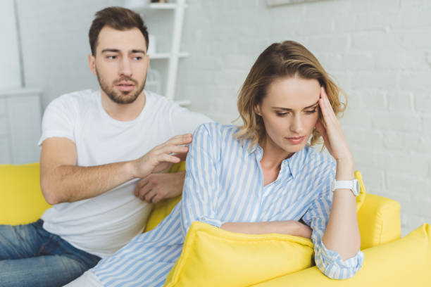 istock Man trying to calm down upset girlfriend in modern room 951180134