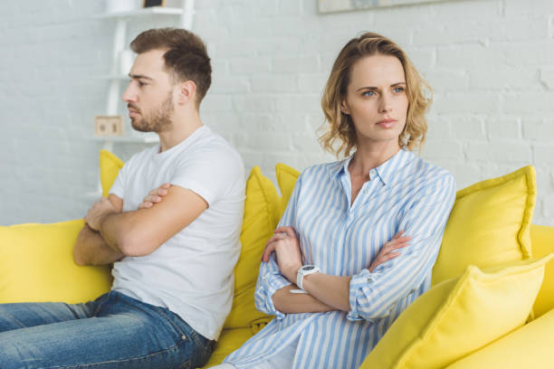 istock Upset couple sitting on yellow couch after argue 951185730